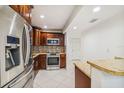 An updated kitchen with stainless steel appliances, granite countertops and mosaic backsplash at 7512 Dolonita Dr # 7512, Tampa, FL 33615