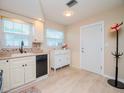 Well-lit kitchen featuring white cabinets, modern appliances, and tiled backsplash at 7755 39Th N Ave, St Petersburg, FL 33709