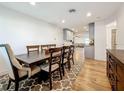 Elegant dining room featuring a long wooden table set upon a patterned rug and hardwood flooring at 777 62Nd N Ave, St Petersburg, FL 33702