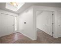 Bright entryway with neutral walls, tiled flooring, and direct access to a carpeted hallway at 891 Lantern Way # 13-103, Clearwater, FL 33765