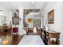 Inviting home foyer boasting wood floors, staircase, and views of the dining and living areas at 9402 59Th N St, Pinellas Park, FL 33782