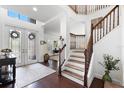 Elegant home foyer featuring hardwood floors, a staircase, and a decorative glass front door at 9402 59Th N St, Pinellas Park, FL 33782