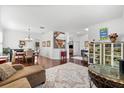 Open-concept living room with wood floors, a dining area, and plenty of natural light at 9402 59Th N St, Pinellas Park, FL 33782