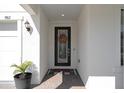 Home's entryway featuring a decorative wreath on the front door and a 'Hello' doormat at 9817 Coneflower Ct, Land O Lakes, FL 34637