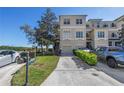 Charming three-story townhome with attached garage, driveway and a well-manicured front yard at 1196 Gandy Crest Ne Dr, St Petersburg, FL 33702