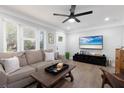 Relaxing living room with wood floors, a comfortable sofa, and a large TV at 1236 36Th N Ave, St Petersburg, FL 33704