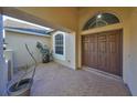 Inviting entryway featuring double doors, a brick-paved patio, and tasteful landscaping for a warm welcome at 13719 Artesa Bell Dr, Riverview, FL 33579