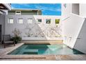 Private plunge pool surrounded by a white wall with plants and a serene seating area at 145 16Th Ne Ave, St Petersburg, FL 33704