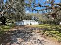 Quaint one-story home with attached garage and landscaping at 1502 S Wiggins Rd, Plant City, FL 33566