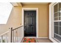 Welcoming front door with decorative accents and a charming seashell doormat at 2028 Kings Palace Dr # 202, Riverview, FL 33578