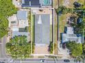 Birds-eye view of the property highlighting the roof, lush back yard, and brick driveway at 2121 Park N St, St Petersburg, FL 33710