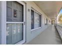 Exterior view of unit #57 featuring secure entrance, storm door and covered entry way at 2401 Ecuadorian Way # 57, Clearwater, FL 33763