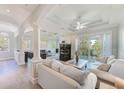 Bright and airy living room with fireplace, balcony access, and stylish decor at 250 Seagate Ct, Dunedin, FL 34698