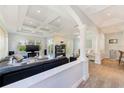 Spacious living room with coffered ceiling, modern fireplace, and wood-look floors at 250 Seagate Ct, Dunedin, FL 34698