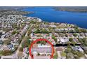 Picturesque aerial shot of a home featuring a pool, lush foliage, near a beautiful, serene lake at 3105 S Canal Dr, Palm Harbor, FL 34684