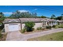 Charming single-Gathering home with a brick driveway, a one car garage, and inviting front porch at 3105 S Canal Dr, Palm Harbor, FL 34684