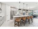 Spacious kitchen featuring a large island with seating and stainless steel appliances at 4574 Freccia Loop, Wesley Chapel, FL 33543