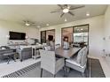 Inviting covered patio area with dining and seating, perfect for outdoor entertaining at 4574 Freccia Loop, Wesley Chapel, FL 33543