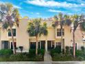 Inviting townhome exterior with beautiful palm trees and manicured landscaping at 5100 Burchette Rd # 3403, Tampa, FL 33647