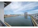 Water view from the balcony with views of new constuction townhomes and a nearby hi-rise at 5351 Bridge St # 99, Tampa, FL 33611