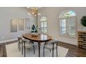 Elegant dining room with a modern chandelier, stylish decor, and large windows providing natural light at 609 Osceola Rd, Belleair, FL 33756