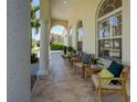 Inviting front porch with comfortable seating, stylish pillows, and bright windows for enjoying outdoor views at 609 Osceola Rd, Belleair, FL 33756