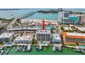 Aerial shot of waterfront condo with private docks and a community pool at 706 Bayway Blvd # 301, Clearwater Beach, FL 33767