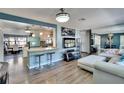 Inviting living space with blue accent wall, modern decor, and open layout connecting to the kitchen at 725 Philippe Pkwy, Safety Harbor, FL 34695