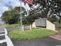 Community sign for Village Lake Condominiums with a manicured lawn at 730 S Village N Dr # 101, St Petersburg, FL 33716