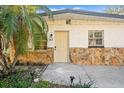 Close-up of a home's entrance, highlighting the stone details, front door, and address number at 7301 S Swoope St, Tampa, FL 33616