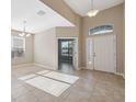 Bright foyer featuring tile flooring and an open floor plan with access to other rooms at 7326 Blue Beech Dr, Riverview, FL 33578