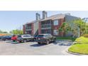 Exterior of a condo with parking lot and multiple cars parked in a waterfront community with lush landscaping at 9100 Dr Martin Luther King Jr N St # 405, St Petersburg, FL 33702