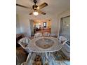 Covered patio featuring a table with six chairs perfect for outdoor dining and relaxation at 1010 Bowsprit Ln # 0, Holiday, FL 34691