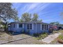 Well-maintained home showcasing its simple design, cozy atmosphere and neat landscaping at 10128 114Th N Ter, Largo, FL 33773