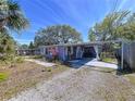 Quaint home boasting a covered patio, lush landscaping, and inviting curb appeal at 10128 114Th N Ter, Largo, FL 33773