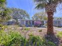 Inviting single-story home with lush landscaping and a welcoming front yard at 10128 114Th N Ter, Largo, FL 33773