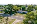 An aerial shot of a light grey single-story house with a wide front yard and an expansive green lawn at 1211 E Camellia Dr., Brandon, FL 33510
