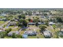 An aerial view showcases a single-story home nestled in a lush neighborhood with mature trees and vibrant landscaping at 1211 E Camellia Dr., Brandon, FL 33510