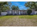 The home boasts a well-kept lawn, tidy landscaping, and a welcoming facade, set against a clear, sunny sky at 1211 E Camellia Dr., Brandon, FL 33510