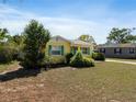 This quaint yellow house boasts eye-catching blue shutters and a neatly kept lawn at 1223 Union St, Clearwater, FL 33755