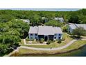 Aerial view of condos surrounded by lush landscaping and water features at 1337 Pine Ridge E Cir # D2, Tarpon Springs, FL 34688