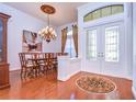 Elegant dining room boasting hardwood floors, decorative chandelier and double doors at 16318 Palmettoglen Ct, Lithia, FL 33547