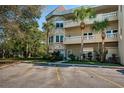 Well-kept condo exterior with private parking, lush landscaping, and charming architectural details at 2019 Utopian W Dr # 310, Clearwater, FL 33763