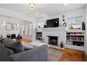 Bright living room features a painted brick fireplace, built-in bookshelves, and hardwood floors at 2222 N Ridgewood Ave, Tampa, FL 33602