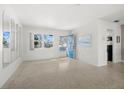 Inviting living room with ample natural light and sleek terrazzo flooring at 223 94Th Ne Ave, St Petersburg, FL 33702