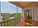 Balcony view of the community pool area surrounded by vibrant, mature trees and blue skies at 4207 S Dale Mabry Hwy # 2412, Tampa, FL 33611