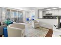 Bright living room featuring a balcony with city views and an open floor plan with a combined dining area at 470 3Rd S St # 814, St Petersburg, FL 33701