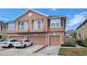 Charming townhouse featuring a stone facade, individual garages, and quaint balconies on the second level at 565 52Nd N Ave, St Petersburg, FL 33703