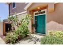 Inviting entryway featuring a vibrant teal door, lush greenery, and decorative plants creating a welcoming ambiance at 565 52Nd N Ave, St Petersburg, FL 33703