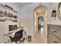 Well-lit hallway features tile flooring, decor and office nook with desk and chair at 708 Barclay Wood Dr, Ruskin, FL 33570